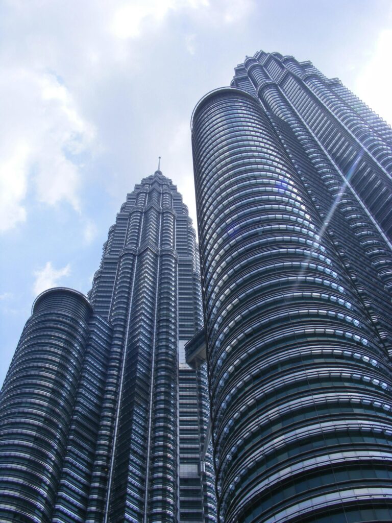 Majestic view of the iconic Petronas Twin Towers in Kuala Lumpur during daytime.